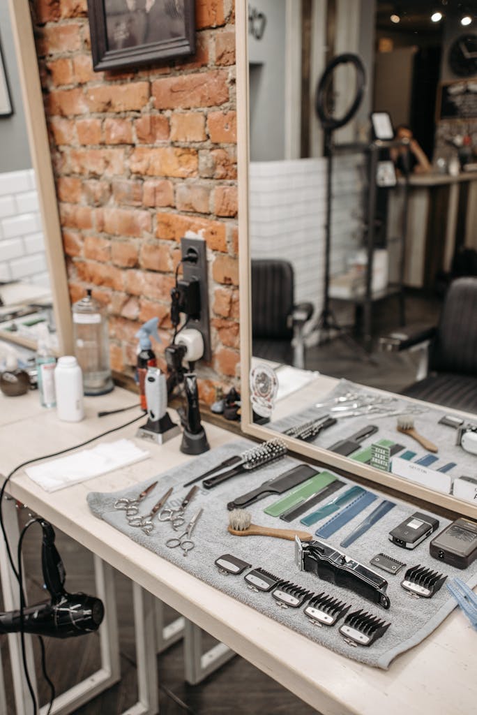 Neatly arranged barber tools in a stylish salon setting with brick wall.