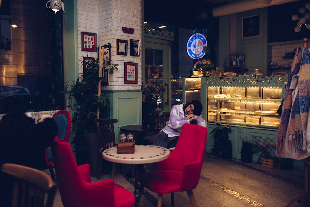 Warm and inviting cafe interior featuring people relaxing and enjoying cozy ambiance.