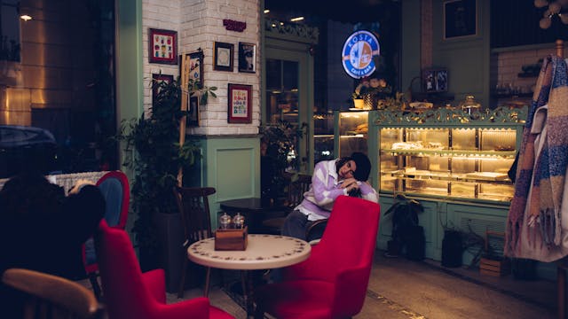 Warm and inviting cafe interior featuring people relaxing and enjoying cozy ambiance.
